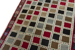 Backside of handmade 2000s Persian Gabbeh rug showing knot structure and weave density