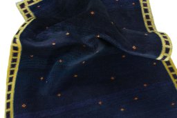Corner detail of 2000s Persian Gabbeh rug showing border pattern and Wool pile