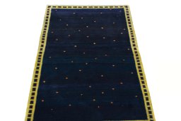 Surface texture of 2000s Persian Gabbeh rug with natural Wool and intricate pattern