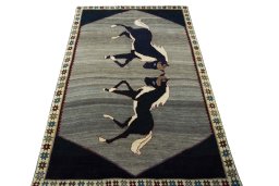 Surface texture of 2000s Persian Gabbeh rug with natural Wool and intricate pattern