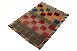 Corner detail of 2000s Persian Gabbeh rug showing border pattern and Wool pile
