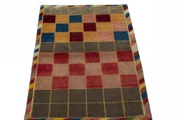Surface texture of 2000s Persian Gabbeh rug with natural Wool and intricate pattern