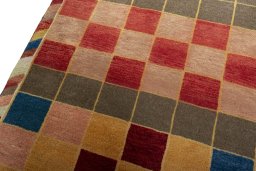 Backside of handmade 2000s Persian Gabbeh rug showing knot structure and weave density