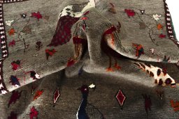 Corner detail of 2000s Persian Gabbeh rug showing border pattern and Wool pile