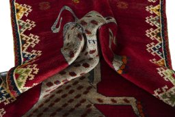 Corner detail of 2000s Persian Gabbeh rug showing border pattern and Wool pile