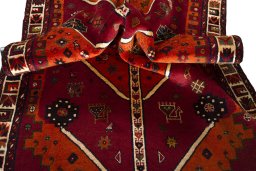 Corner detail of 2000s Persian Gabbeh rug showing border pattern and Wool pile