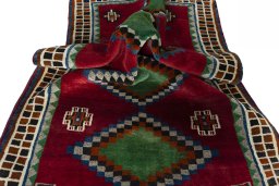 Corner detail of 2000s Persian Gabbeh rug showing border pattern and Wool pile