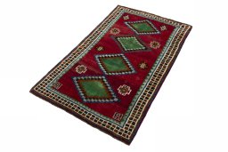 Corner detail of 2000s Persian Gabbeh rug showing border pattern and Wool pile