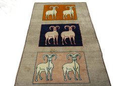 Surface texture of 2000s Persian Gabbeh rug with natural Wool and intricate pattern