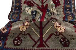Corner detail of 2000s Persian Gabbeh rug showing border pattern and Wool pile