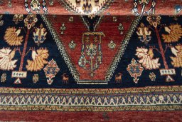 Corner detail of 2000s Persian Gabbeh rug showing border pattern and Wool pile