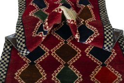 Corner detail of 2000s Persian Gabbeh rug showing border pattern and Wool pile