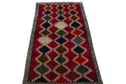 Surface texture of 2000s Persian Gabbeh rug with natural Wool and intricate pattern