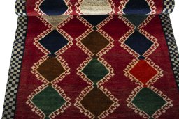Full view of 2000s Persian Gabbeh rug from Iran / Persia, 178 × 88 cm in Red tones
