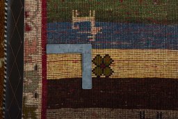 Corner detail of 2000s Persian Gabbeh rug showing border pattern and Wool pile