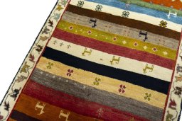 Surface texture of 2000s Persian Gabbeh rug with natural Wool and intricate pattern