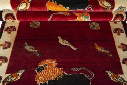 Corner detail of 2000s Persian Gabbeh rug showing border pattern and Wool pile