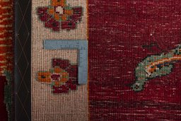 Surface texture of 2000s Persian Gabbeh rug with natural Wool and intricate pattern