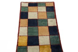Surface texture of 2000s Persian Gabbeh rug with natural Wool and intricate pattern