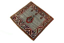 Corner detail of 2000s Persian Gabbeh rug showing border pattern and Wool pile