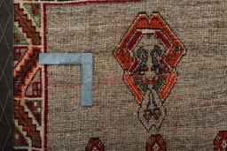 Backside of handmade 2000s Persian Gabbeh rug showing knot structure and weave density