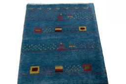 Surface texture of 2000s Persian Gabbeh rug with natural Wool and intricate pattern