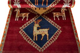 Full view of 2000s Persian Gabbeh rug from Iran / Persia, 193 × 100 cm in Red tones