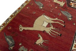 Backside of handmade 2000s Persian Gabbeh rug showing knot structure and weave density