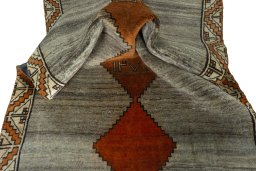 Corner detail of 2000s Persian Gabbeh rug showing border pattern and Wool pile