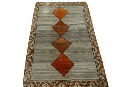 Surface texture of 2000s Persian Gabbeh rug with natural Wool and intricate pattern