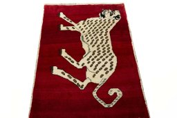 Surface texture of 2000s Persian Gabbeh rug with natural Wool and intricate pattern