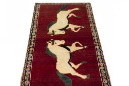 Surface texture of 2000s Persian Gabbeh rug with natural Wool and intricate pattern