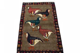 Surface texture of 2000s Persian Gabbeh rug with natural Wool and intricate pattern