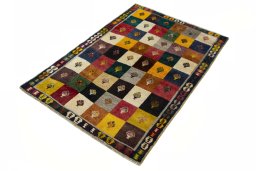 Corner detail of 2000s Persian Gabbeh rug showing border pattern and Wool pile