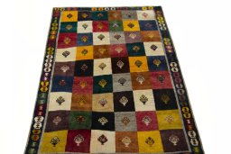 Surface texture of 2000s Persian Gabbeh rug with natural Wool and intricate pattern