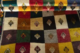 Full view of 2000s Persian Gabbeh rug from Iran / Persia, 192 × 127 cm in Multi Color tones