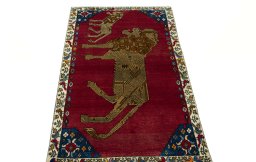 Surface texture of 2000s Persian Gabbeh rug with natural Wool and intricate pattern