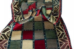 Corner detail of 2000s Persian Gabbeh rug showing border pattern and Wool pile