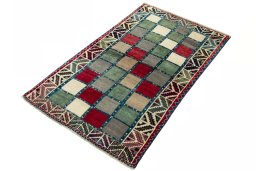 Corner detail of 2000s Persian Gabbeh rug showing border pattern and Wool pile