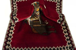Corner detail of 2000s Persian Gabbeh rug showing border pattern and Wool pile
