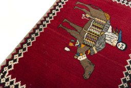 Backside of handmade 2000s Persian Gabbeh rug showing knot structure and weave density