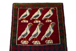 Surface texture of 2000s Persian Gabbeh rug with natural Wool and intricate pattern