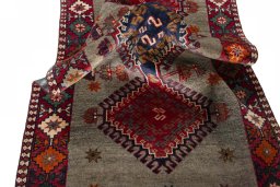 Corner detail of 2000s Persian Gabbeh rug showing border pattern and Wool pile