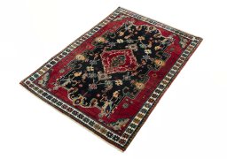 Corner detail of 2000s Persian Gabbeh rug showing border pattern and Wool pile