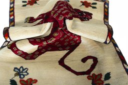 Corner detail of 2000s Persian Gabbeh rug showing border pattern and Wool pile