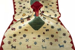 Corner detail of 2000s Persian Gabbeh rug showing border pattern and Wool pile