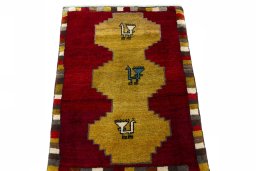 Surface texture of 2000s Persian Gabbeh rug with natural Wool and intricate pattern
