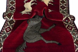 Corner detail of 2000s Persian Gabbeh rug showing border pattern and Wool pile