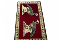 Surface texture of 2000s Persian Gabbeh rug with natural Wool and intricate pattern