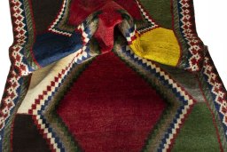 Corner detail of 2000s Persian Gabbeh rug showing border pattern and Wool pile